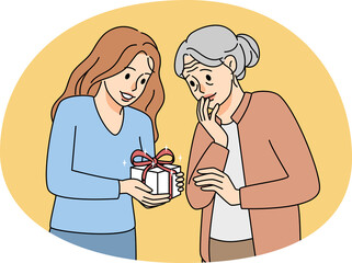 Caring young woman greeting elderly grandmother