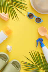 Summer skincare tips for children. Top view vertical shot of sunblock cosmetic bottles, beach toys,...