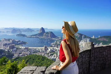 Fotobehang Rio de Janeiro Fashion tourist woman on terrace in Rio de Janeiro with the famous Guanabara bay and the cityscape of Rio de Janerio, Brazil