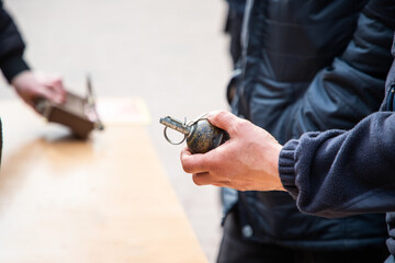 A man holds a military grenade in his hand. Military weapons, mines and grenades russian...