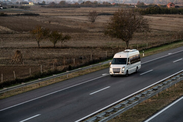 White Small modern comfortable tourist bus driving on the highway. The concept of travel and bus...