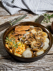 Stewed pork chop in a bright mushroom sauce.