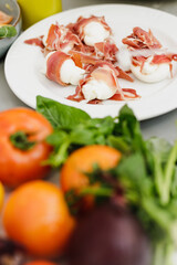 Fresh prosciutto, mozzarella, tomatoes and vegetable on the table.
Prosciutto Wrapped Mozzarella Sticks.
Prosciutto and Mozzarella antipasti.