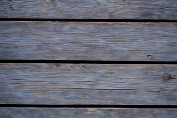 Obraz na płótnie Canvas Old dark gray wood wall for wood background and texture. An old weathered wooden wall with a white paint striped pattern creates a rustic backdrop for your next design project. Generative AI