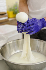 Making mozzarella cheese.
Process of making mozzarella cheese. The balls of cheese.
