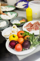 Fresh mozzarella, tomatoes and vegetable on the table