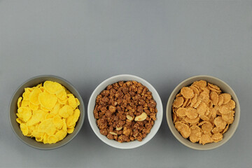Breakfast cereals in bowls on a gray background. Fast food. Top view. Space for text.