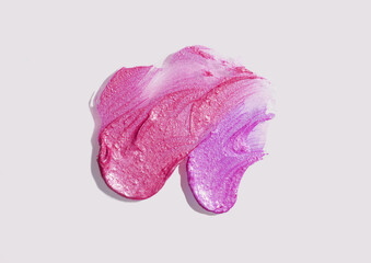 Lipstick lip gloss or balm cherry red purple colored abstract strokes smudge  background texture gray colored isolated