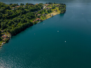 Fototapeta na wymiar Nature of Italy Lake Orta view from a drone. Aerial View Forest Landscape in Summertime Day. Concept Wildlife and Nature Wide Shot 4k.