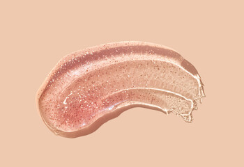 Lipstick lip gloss or balm peach colored abstract shimmer glitter strokes smudge  background...