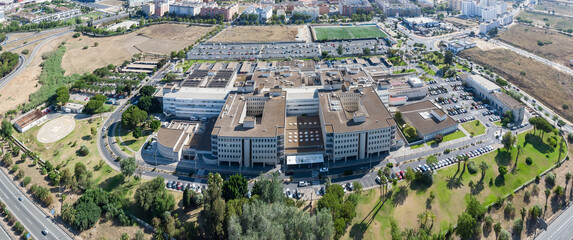 Aerial panoramic drone view of the Juan Ramon Jimenez University Hospital, a public hospital complex belonging to the Andalusian Health Service located in the Spanish city of Huelva - obrazy, fototapety, plakaty