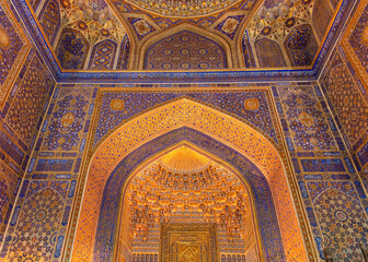 Interior of Tilya Kori Madrasah in Samarkand, Uzbekistan. Masterpiece of XVII century. Mihrab upper part, golden and blue ornaments