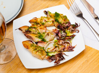 Traditional Korean dish is barbecue squid,drizzled with delicate spinach sauce.