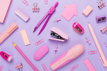 Pink school stationery on color backgroung, top view