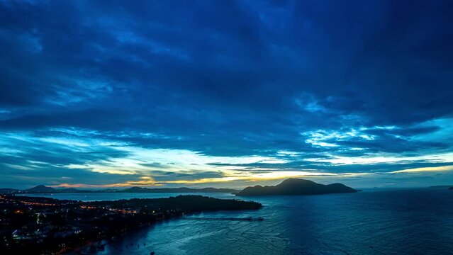 Aerial Hyperlapse view blue cloud moving above the marina of fishing boat at twilight..beautiful sky in nature and travel concept.4K resolution..scenery blue sky in sunrise on the islands background..