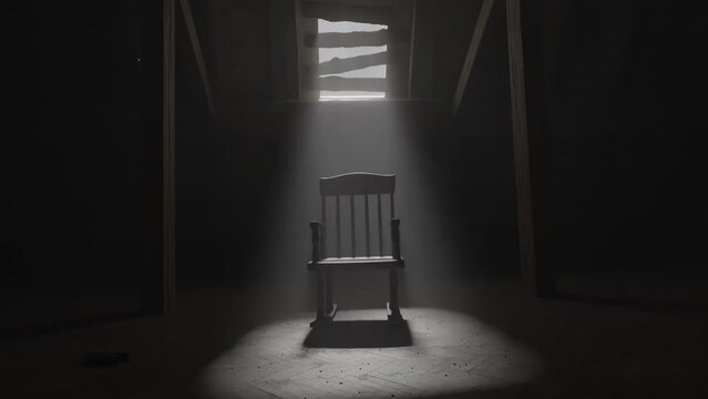 old rocking chair illuminated by light ray at dark attic. Concept age and past