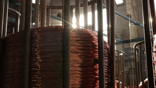 Coil storage, Bare copper, Plant efficiency. Wire manufacturing facility contains large coils copper wire.