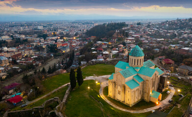 Aerial view of the ancient city of Kutaisi in the evening, located on the banks of the Rioni River, with a view of ..landmark Bagrati Cathedral