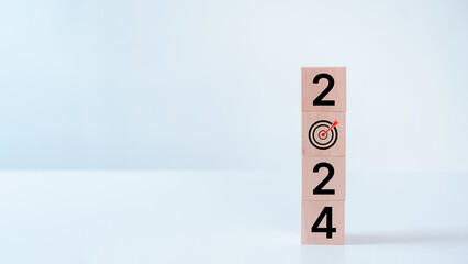 2024 business target goals of business or life. Wooden cubes with 2024 and goal icon on white...