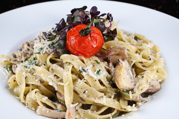 Tagliatelle with mushrooms and dried tomatoes flavored and cheese - 619607417