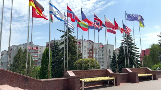 On the square near the government and the parliament, the flags of the countries of the world flutter in the wind on the flagpoles. Flags of nations. The international community