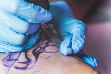 closeup shot of drawing a tattoo, tattoo studio. High quality photo