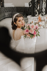 portrait of a young girl from the back, with beautiful hair and makeup in a luxurious wedding dress...