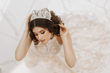Top view, beautiful bride, with a white wedding dress and a luxurious crown on her head. Horizontal...