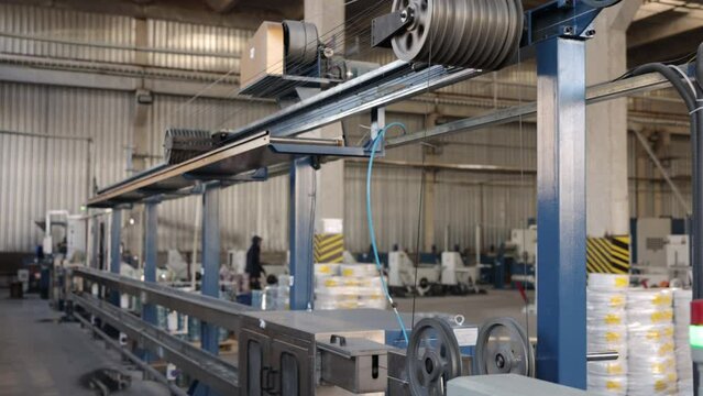 Conveyor system, Production techniques, Manufacturing capacity. Factory dedicated to producing cables with black insulation makes use of conveyor assembly lines.
