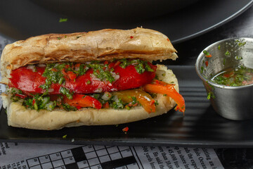 Delicious Argentinian choripan with chimichurri sauce