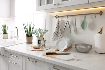 Set of different utensils and dishes on countertop in kitchen
