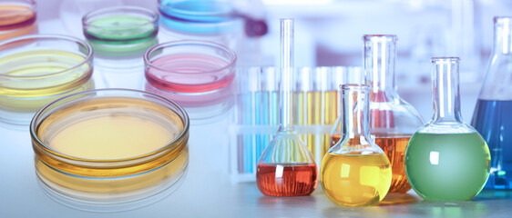 Chemistry and chemical research. Collage of different laboratory glassware with colorful liquids ....
