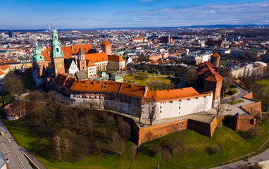 Fototapeta na wymiar Aerial view of Wawel Hill with fortified Castle complex and belfry of Cathedral of Saints Stanislaus and Wenceslaus on sunny spring day, Krakow, Poland..