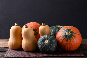 Pumpkin and butternut squash on wooden table with black background, Organic vegetable in Autumn season © nungning20