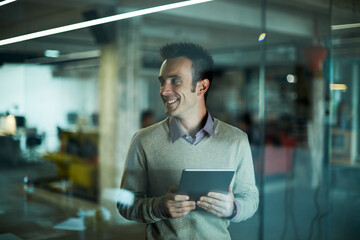 Young man using a digital tablet while working in a startup company office