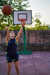 Girl playing basketball in a park