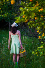 Girl leaving the garden after recolect some lemons