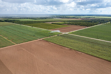 Aerial view of planted and unplanted agricultural fields and irrigation in Homestaed, Florida under summer cloudscape.