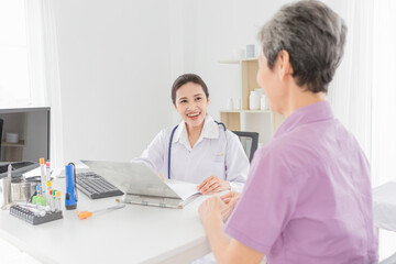 doctor talk with patient in mental health clinic, she screening and write patient information on patient chart, elderly healthcare promotion