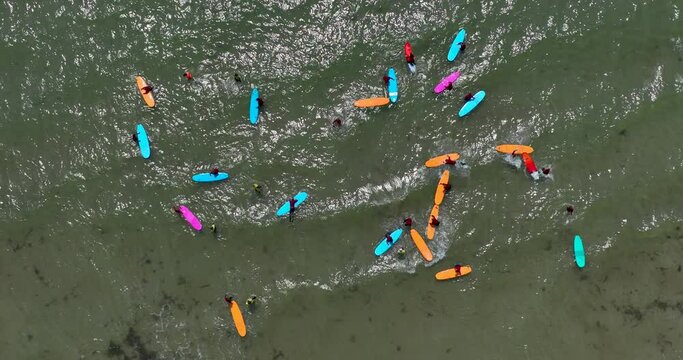 Top view of the beach with surfers waiting for a wave 4k