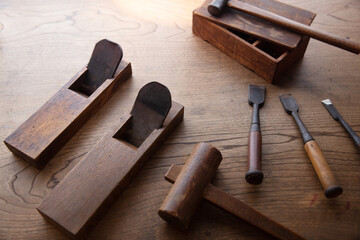 Japanese wood working tools on an old rustic work table. Vintage Japanese block planes, chisels and...