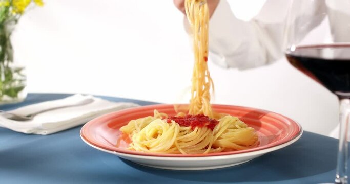 a woman's hand unsuccessfully tries to wind spaghetti on a fork. lunch at a restaurant. close-up. High quality 4k footage