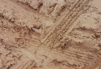 The tire tracks on the dirt road 
