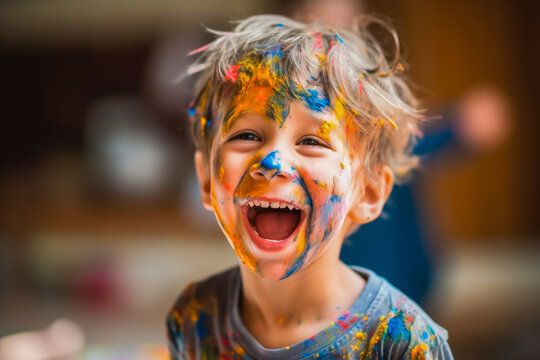 Candid image of a young smiling boy, engaged in painting with paint on his face and hands. Young creative hands, generative ai