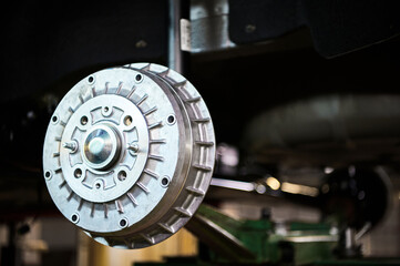 Metal brake drum of contemporary automobile in workshop