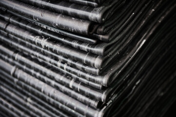 Stack of reinforced tire rubber sheets at production plant