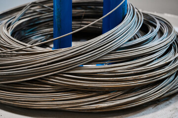 Coils of metal wire in warehouse of metalwork factory