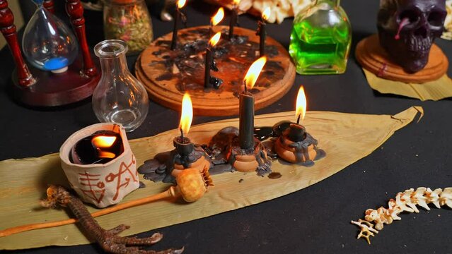 Black magic candles witchcraft composition. Selective focus. Magic ritual satanic tools and items. Halloween and occult black magic ritual imaginary. Ritual scene in dark and frightening atmosphere.