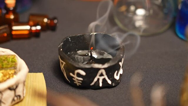 Witchcraft composition selective focus with candles lights, magic items tools and symbols.  Occult and esoteric concept. Mystic Halloween. Magic chemistry and witch craft.