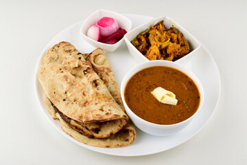 Indian food in plate isolated on white background, dal roti sabji